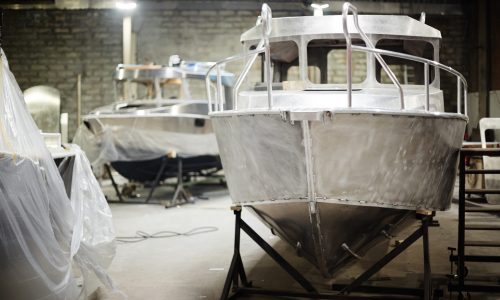 New metallic boats in contemporary boat-production department of factory